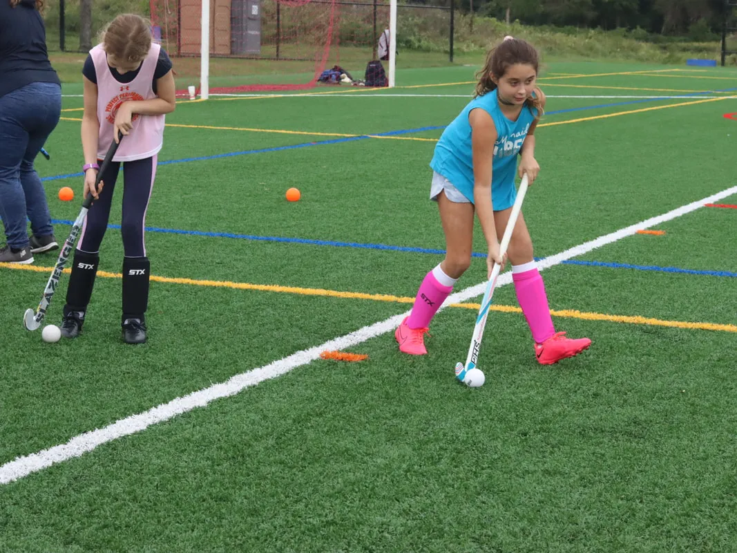 Youth field hockey players training